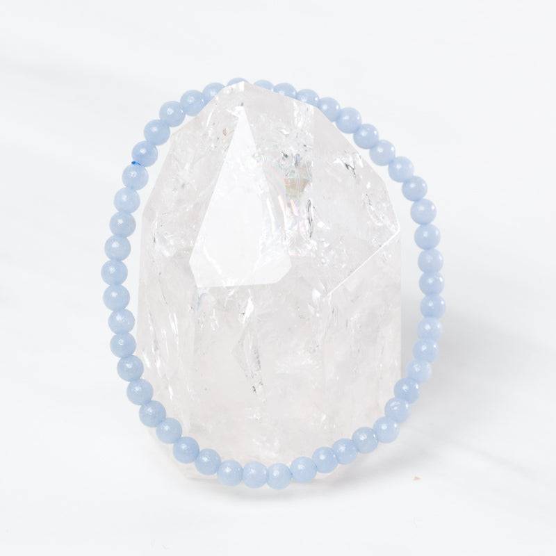 Dainty Angelite bracelet by Milk and Honey featuring smooth blue gemstone beads on a delicate jewelry chain.