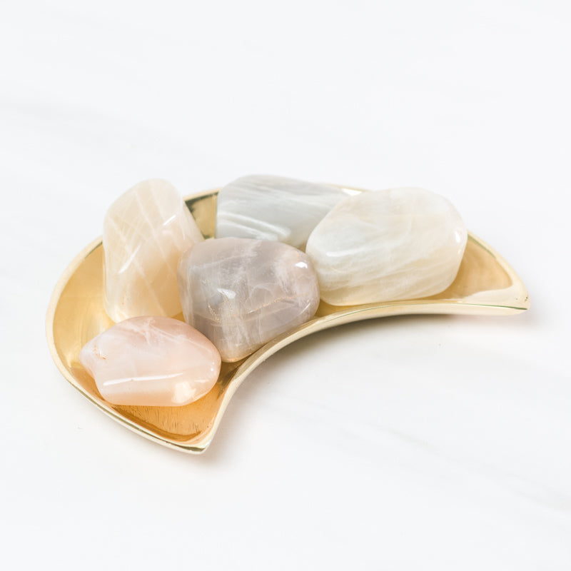Beautiful polished moonstone gemstone from Sacred Light Soundbaths and Crystals, showcasing its iridescent, shimmering surface.