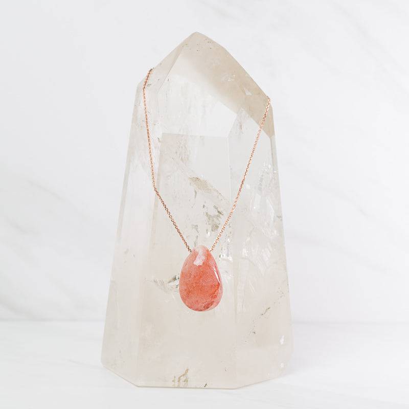 Hematoid teardrop necklace featuring a red and golden crystal pendant on a silver chain, jewelry by Sacred Light Soundbaths and Crystals
