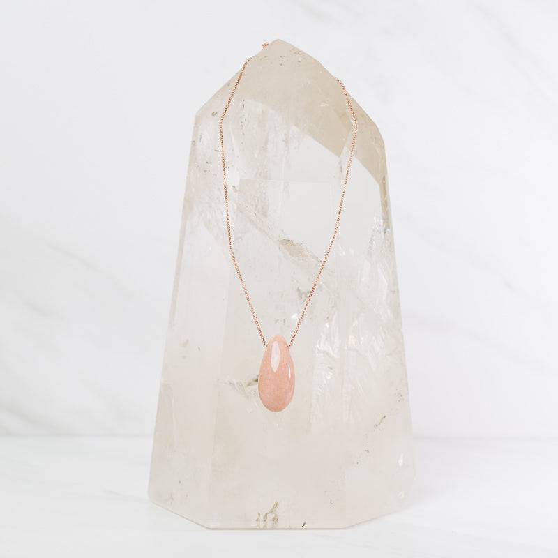 Peach Moonstone teardrop necklace from Sacred Light Soundbaths and Crystals, featuring a polished peach-colored moonstone pendant on a delicate chain.