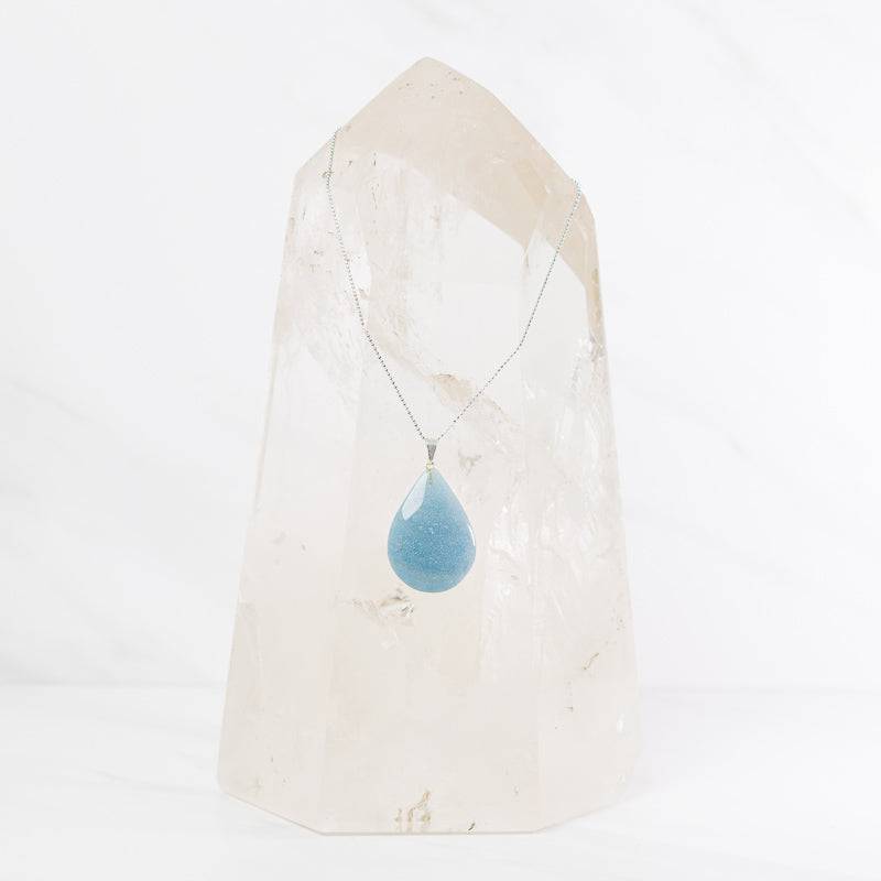 Trolleite teardrop pendant necklace from Sacred Light Soundbaths and Crystals, showcasing a blue-green gemstone on a silver chain.