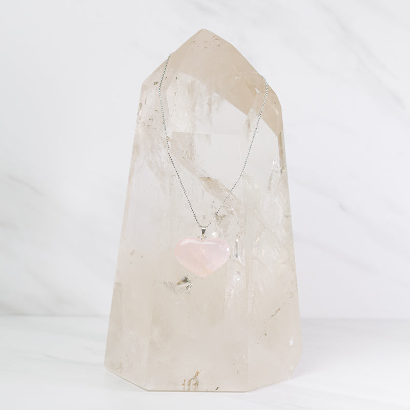 Rose quartz heart necklace on a sterling silver chain from Sacred Light Soundbaths and Crystals, showcasing a delicate jewelry piece.