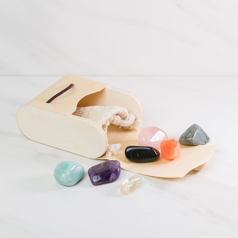 Large chakra gemstone set in a wooden gift box, featuring colorful crystals for chakra alignment by Sacred Light Soundbaths and Crystals.