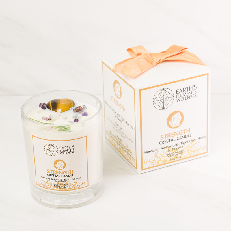 Aromatherapy Strength Candle from Sacred Light Soundbaths and Crystals, featuring a decorative candle with calming design.