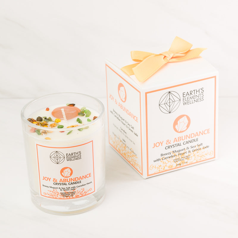 Sacred Light Soundbaths and Crystals Joy and Abundance Aromatherapy Candle with a warm, glowing flame and decorative design.