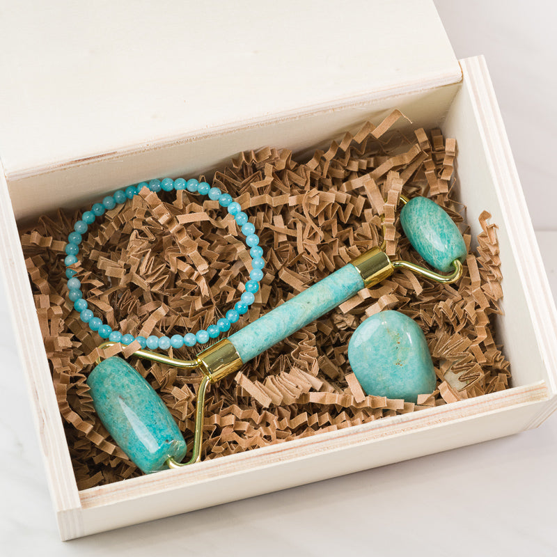 Amazonite soothing face massage roller from Sacred Light Soundbaths and Crystals, with smooth stone surface and ergonomic handle.