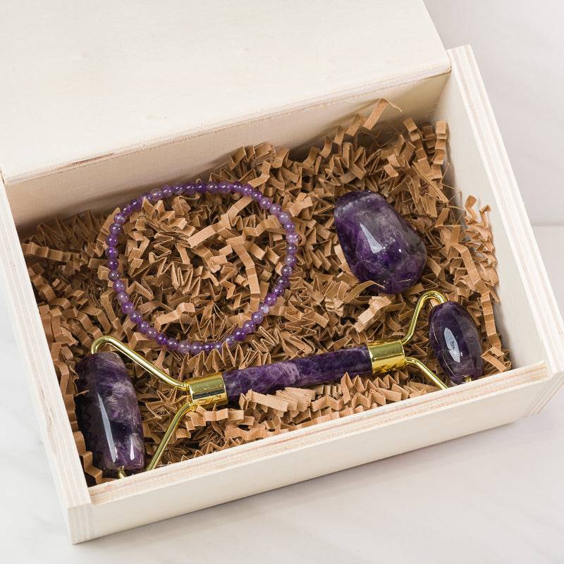 Amethyst face massage roller from Sacred Light Soundbaths and Crystals, soothing skincare accessory with purple crystal handle and roller.