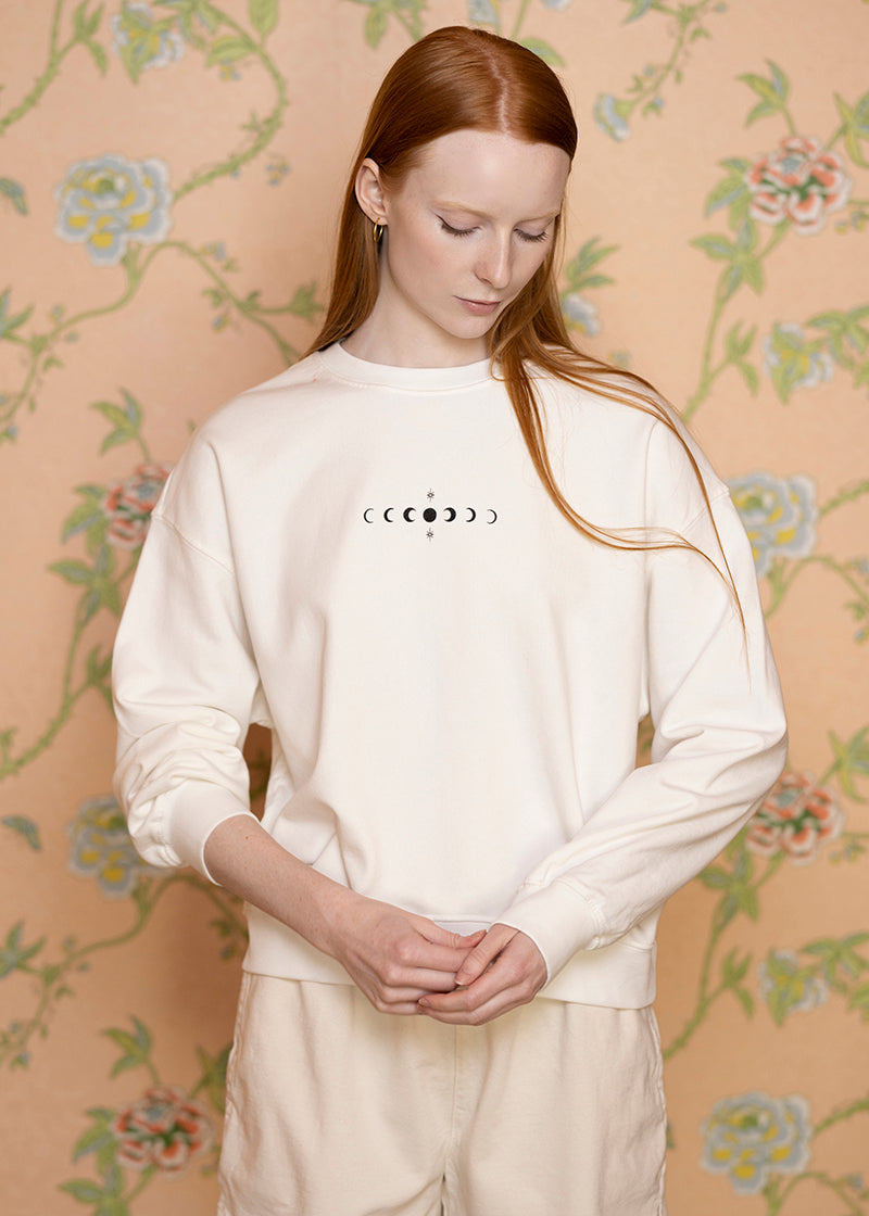 Sacred Light Soundbaths and Crystals moon phases crewneck sweatshirt featuring a celestial moon phases graphic on soft fabric
