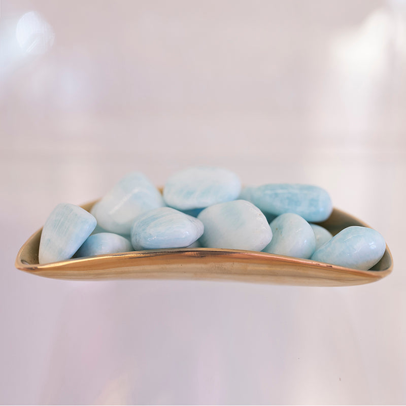 Large tumbled blue Aragonite stone from Sacred Light Soundbaths and Crystals, showing smooth, rounded blue mineral with natural texture.