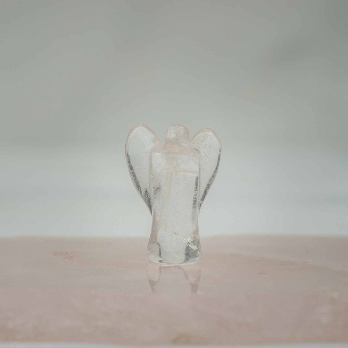 Clear Quartz Pocket Angel stone from Sacred Light Soundbaths and Crystals, featuring a detailed angel shape with clear, polished quartz.