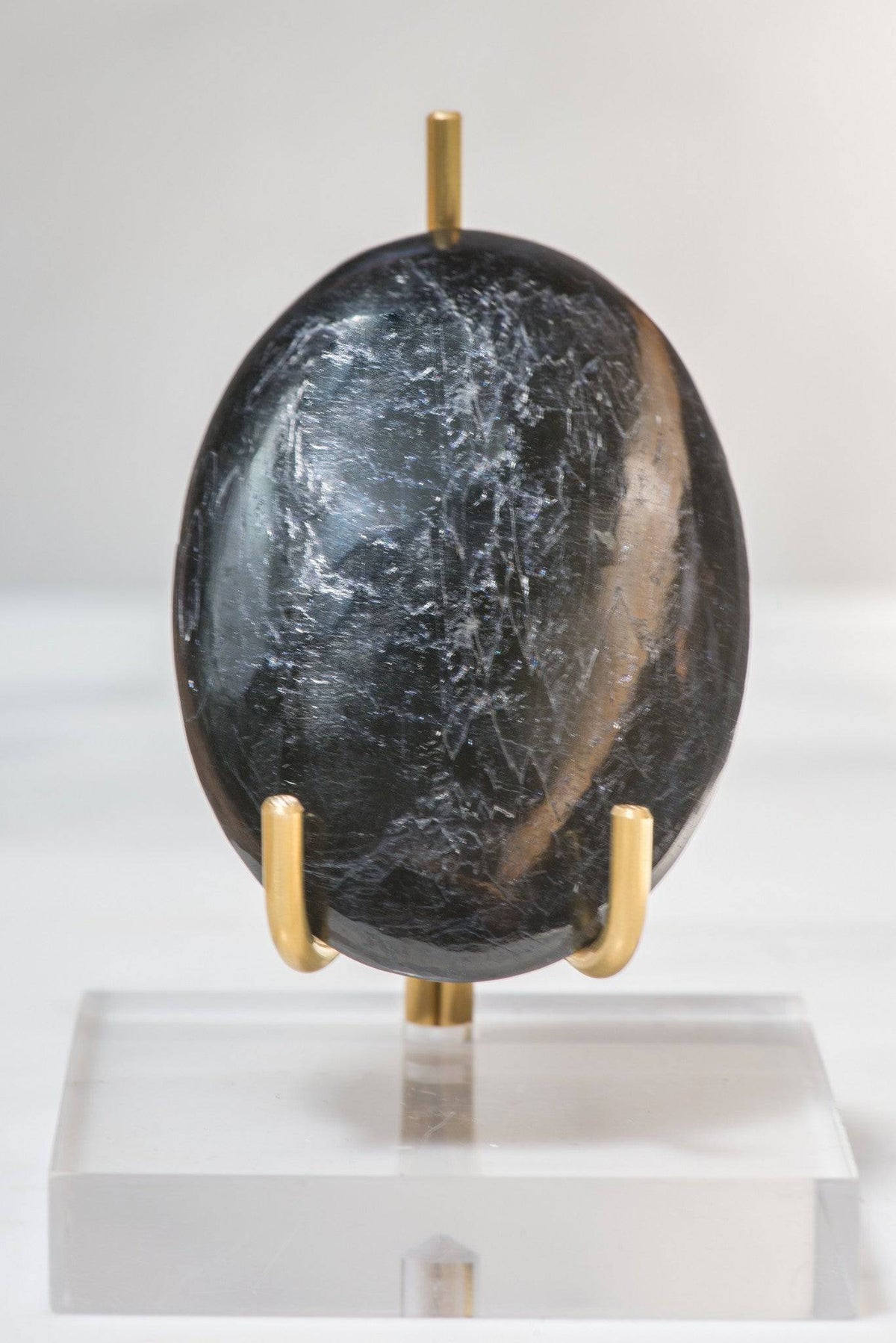 Polished black tourmaline palm stone from Sacred Light Soundbaths and Crystals, smooth black crystal with natural polish, hand-sized healing stone