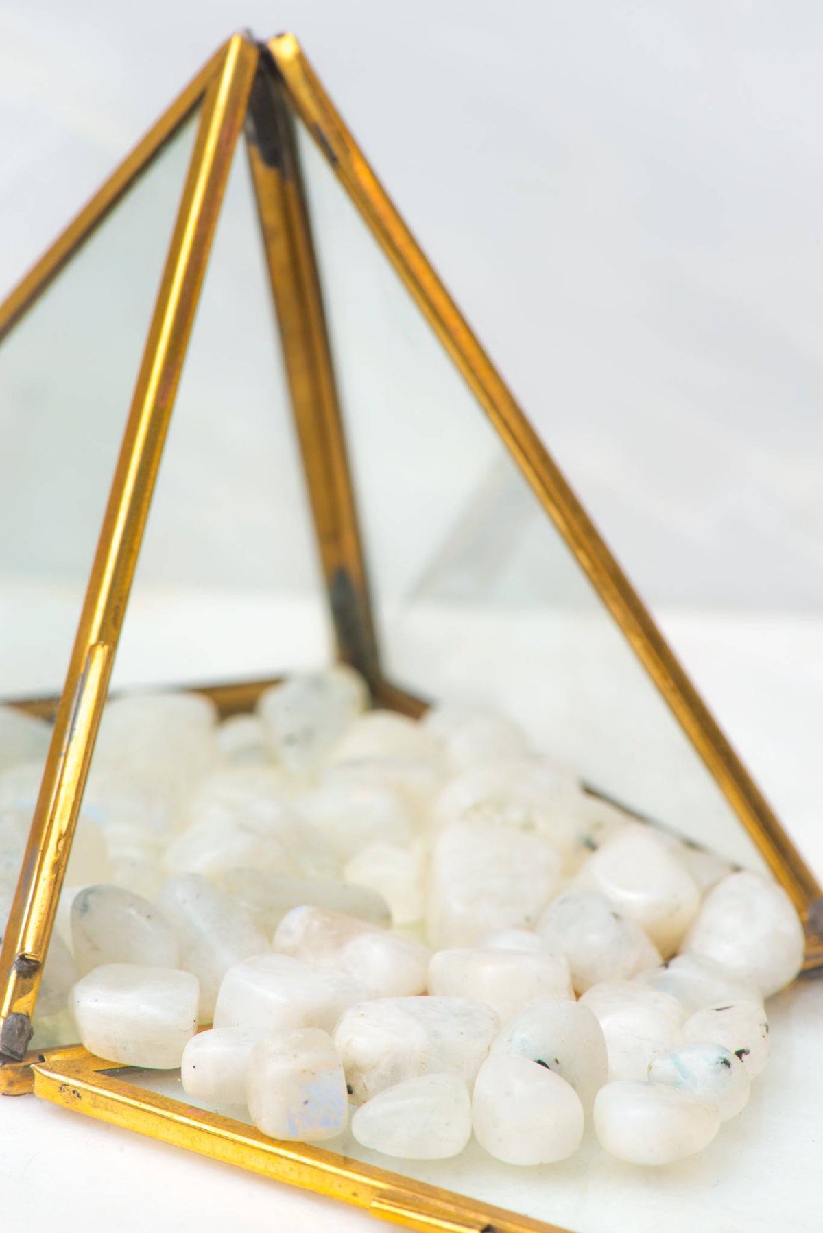 Tumbled rainbow moonstone stone from Sacred Light Soundbaths and Crystals, showcasing its iridescent, smooth surface and natural hues.