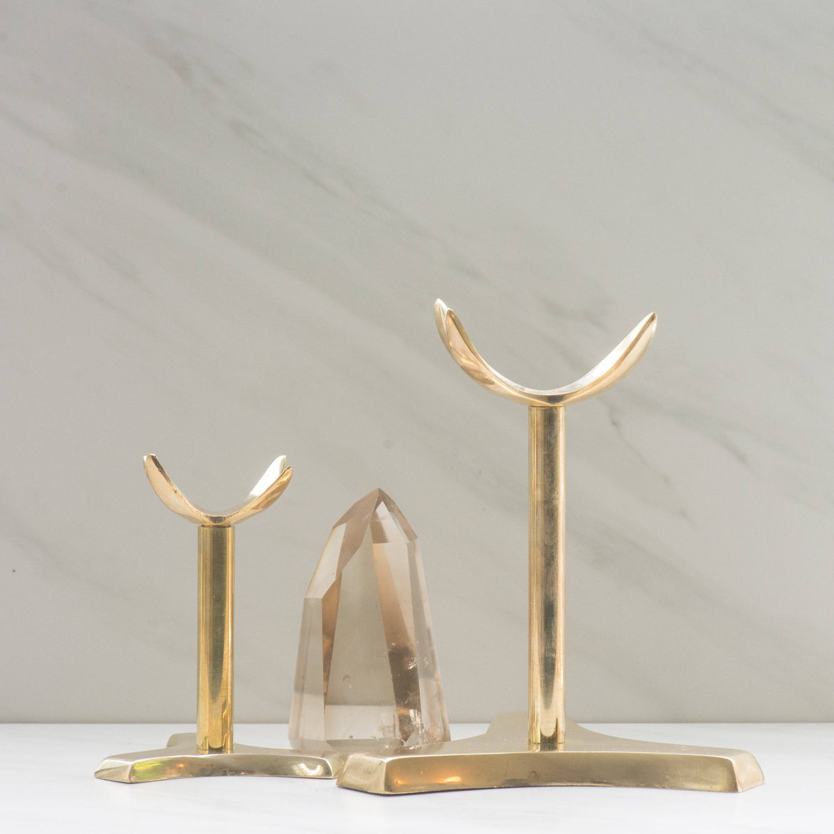 Brass 4-prong crystal specimen stand from Sacred Light Soundbaths and Crystals, showcasing the elegant metal support for crystals.