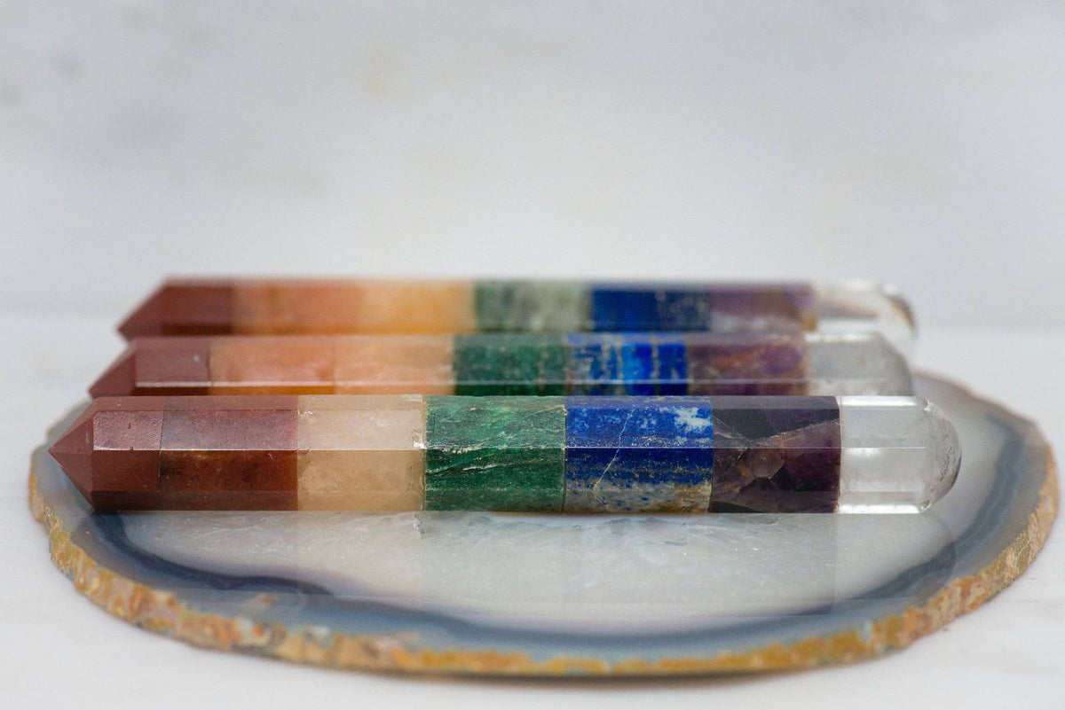 Polished chakra wand from Sacred Light Soundbaths and Crystals, featuring smooth, colorful stones and intricate detailing.