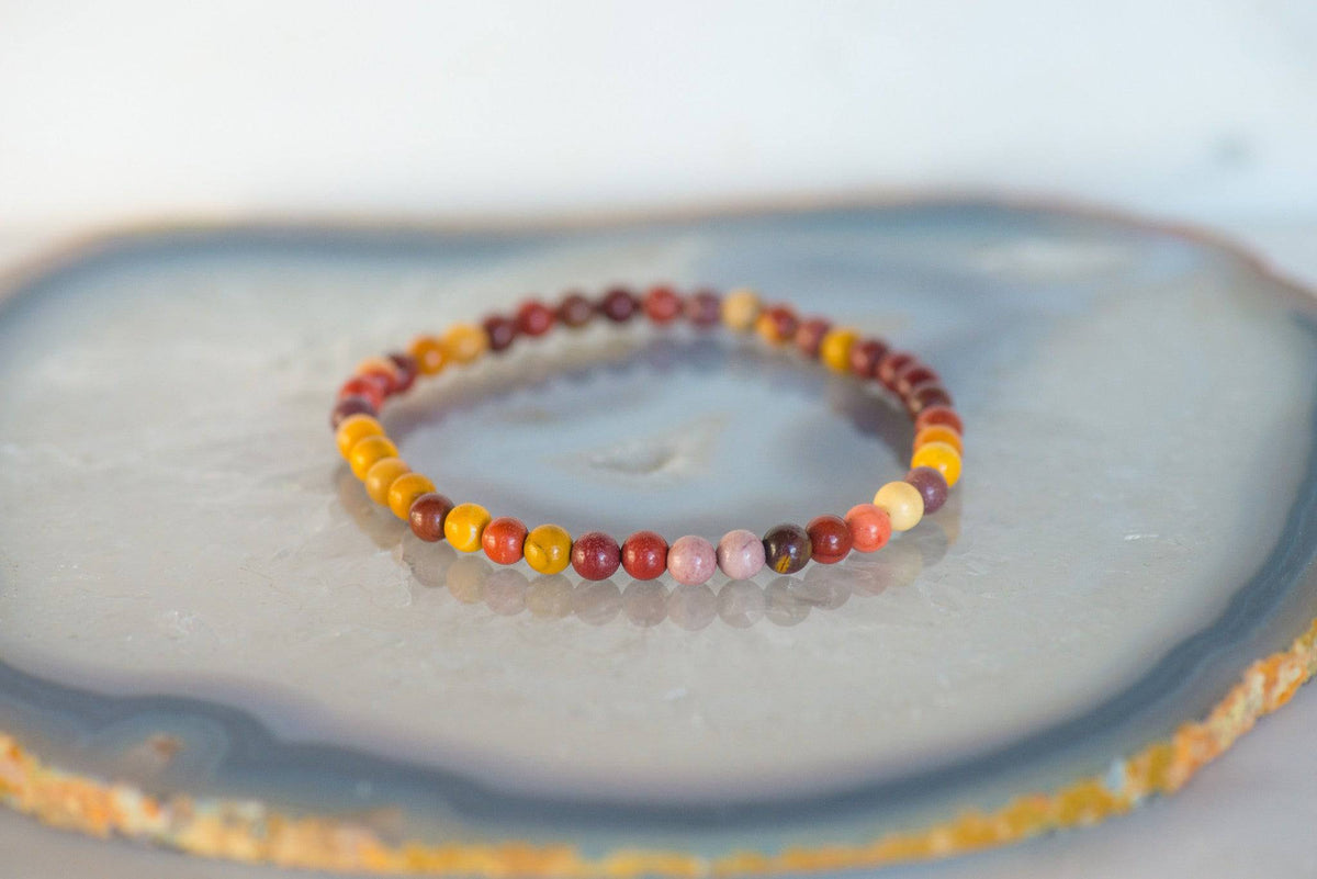 Colorful Mookaite Jasper bracelet from Milk and Honey jewelry collection, featuring polished oval beads on elastic cord.