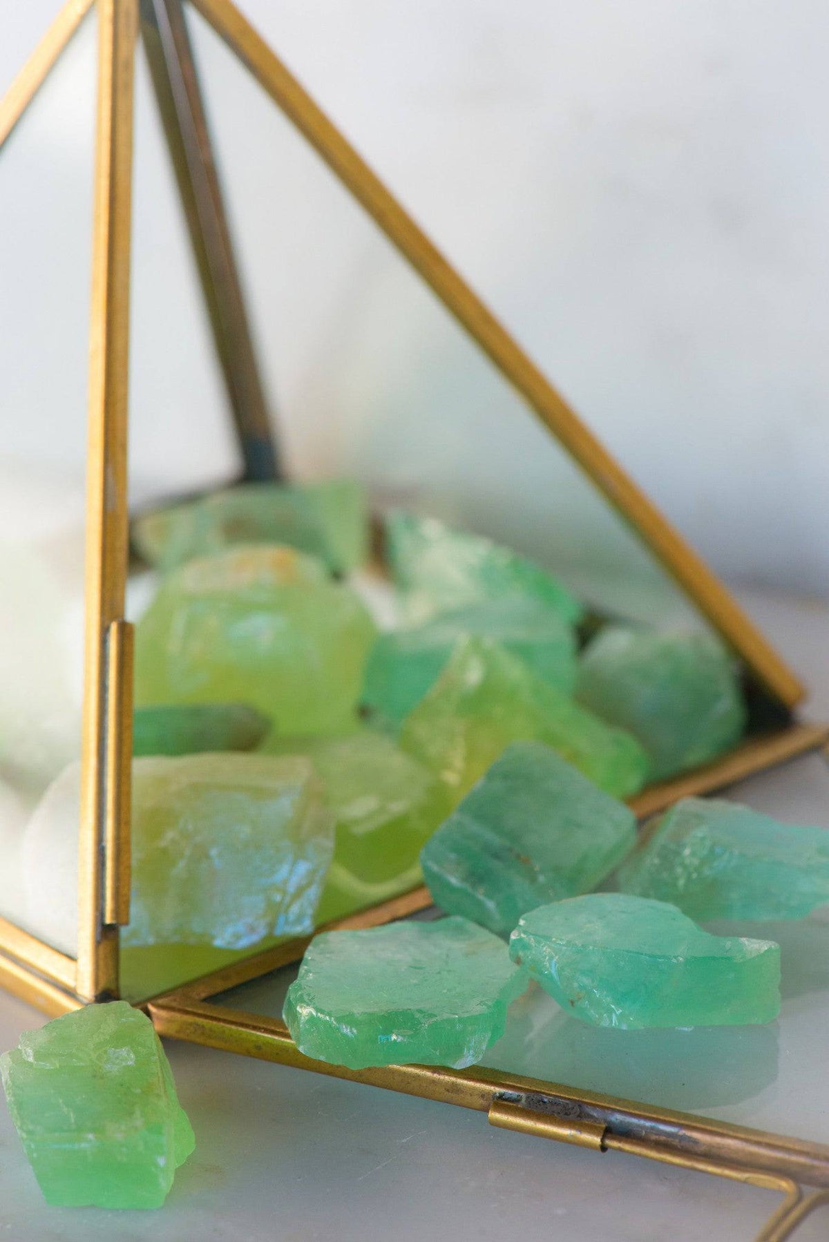Natural green calcite stone from Sacred Light Soundbaths and Crystals, showcasing its vibrant green color and smooth polished surface.