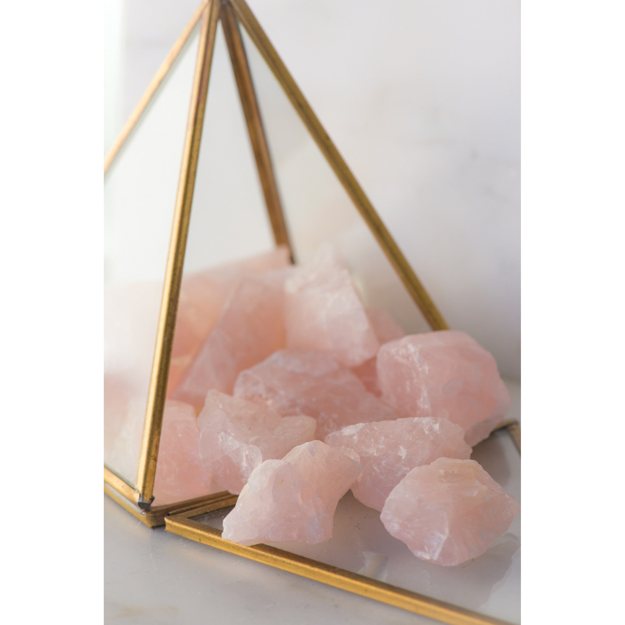 Natural rose quartz stone from Sacred Light Soundbaths and Crystals, showcasing its soft pink color and smooth polished surface.