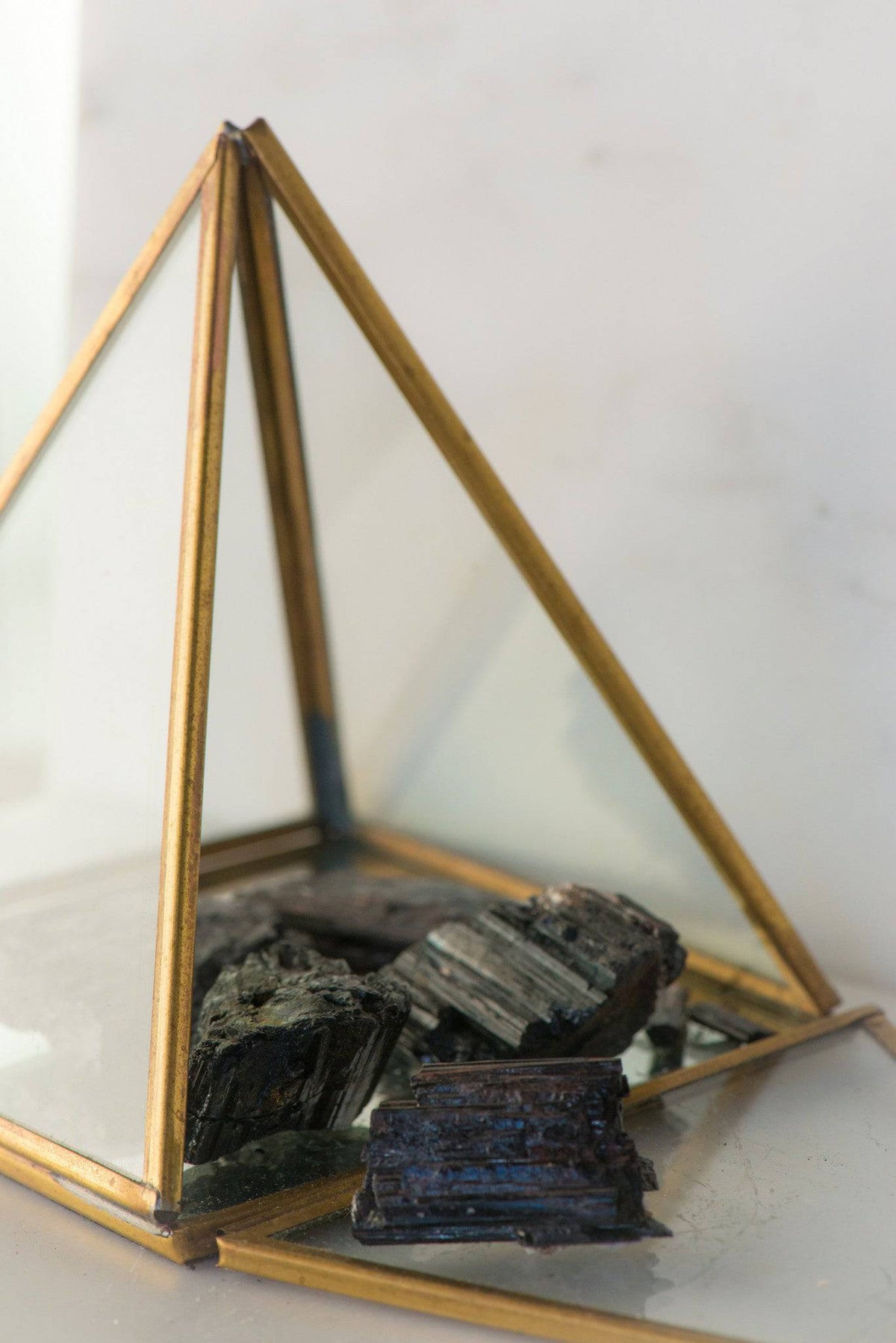 Natural black tourmaline stone from Sacred Light Soundbaths and Crystals, showcasing its polished, deep black mineral surface.