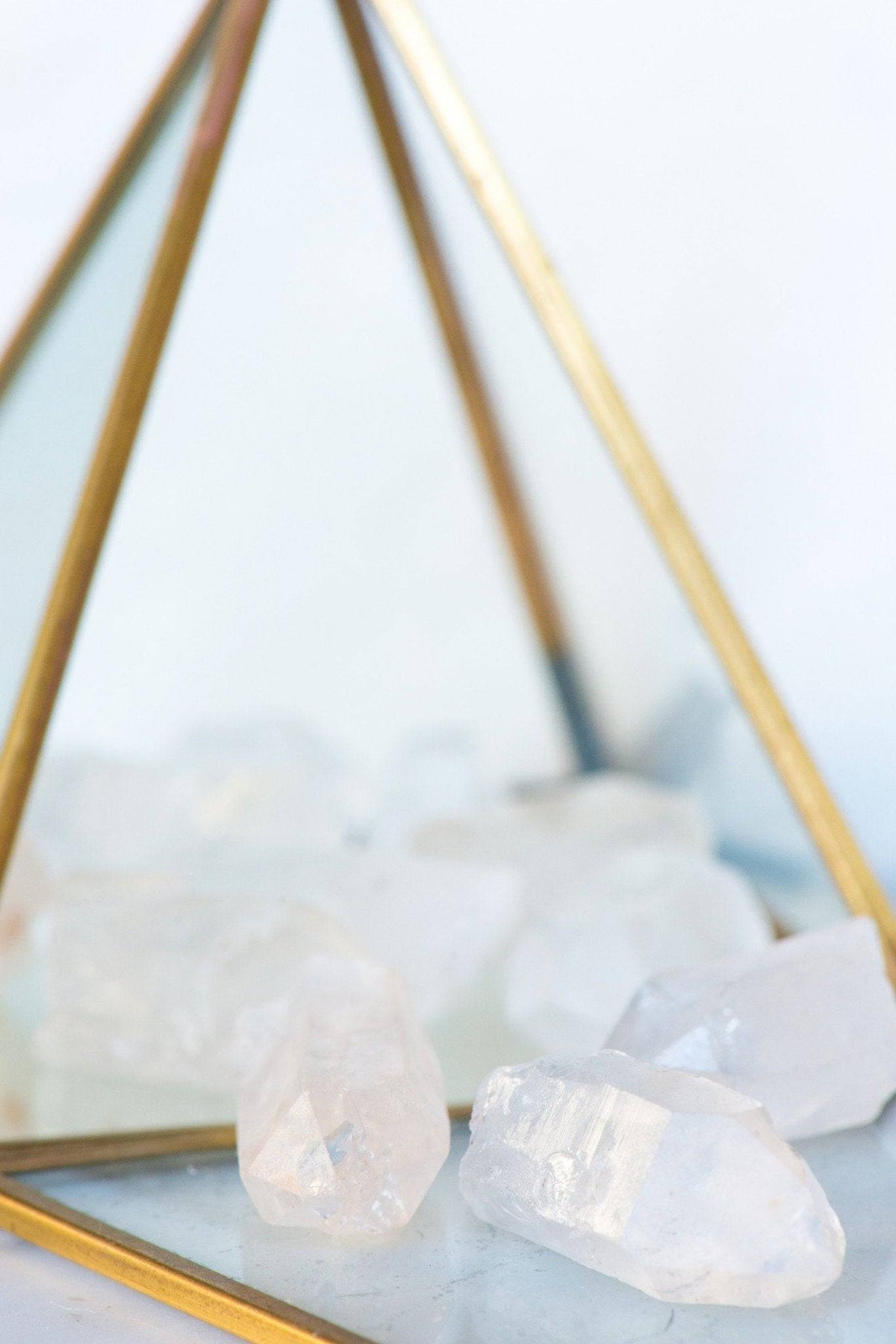 Clear Quartz point stone from Sacred Light Soundbaths and Crystals, polished crystal with natural facets and pointed shape.