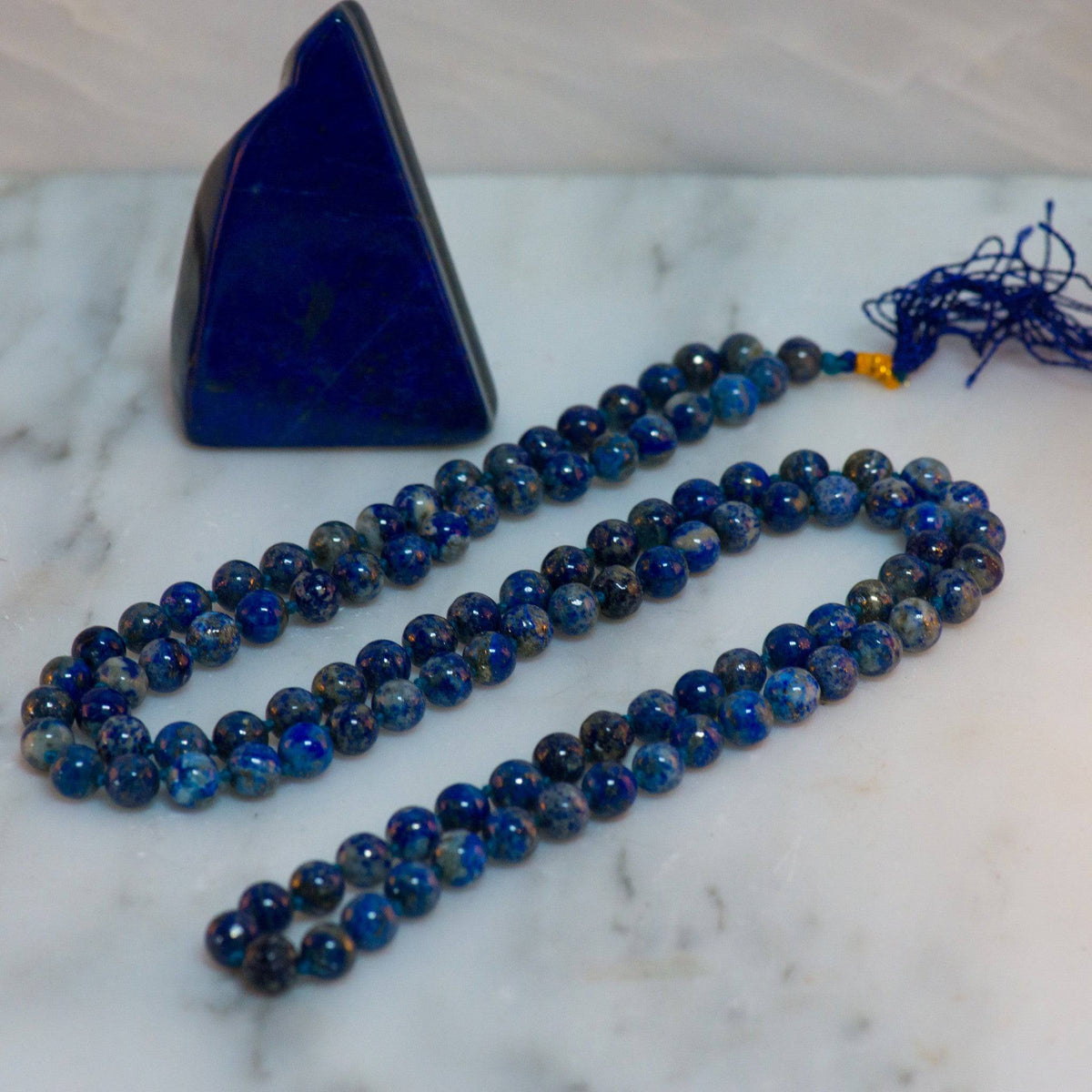 Lapis Lazuli Mala Necklace from Sacred Light Soundbaths and Crystals, featuring deep blue stones with gold flecks, handcrafted jewelry.