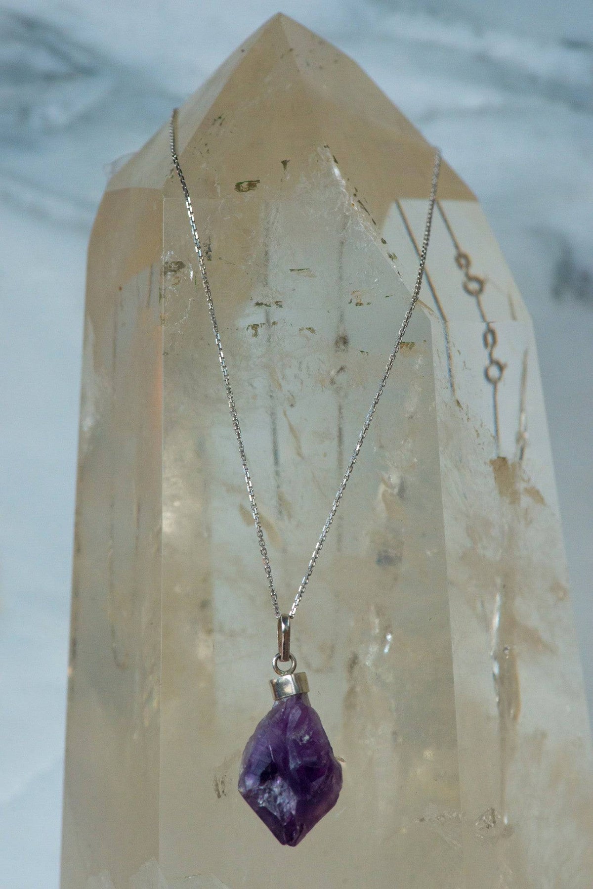 Sterling silver amethyst necklace from Sacred Light Soundbaths and Crystals, featuring a polished purple gemstone pendant.
