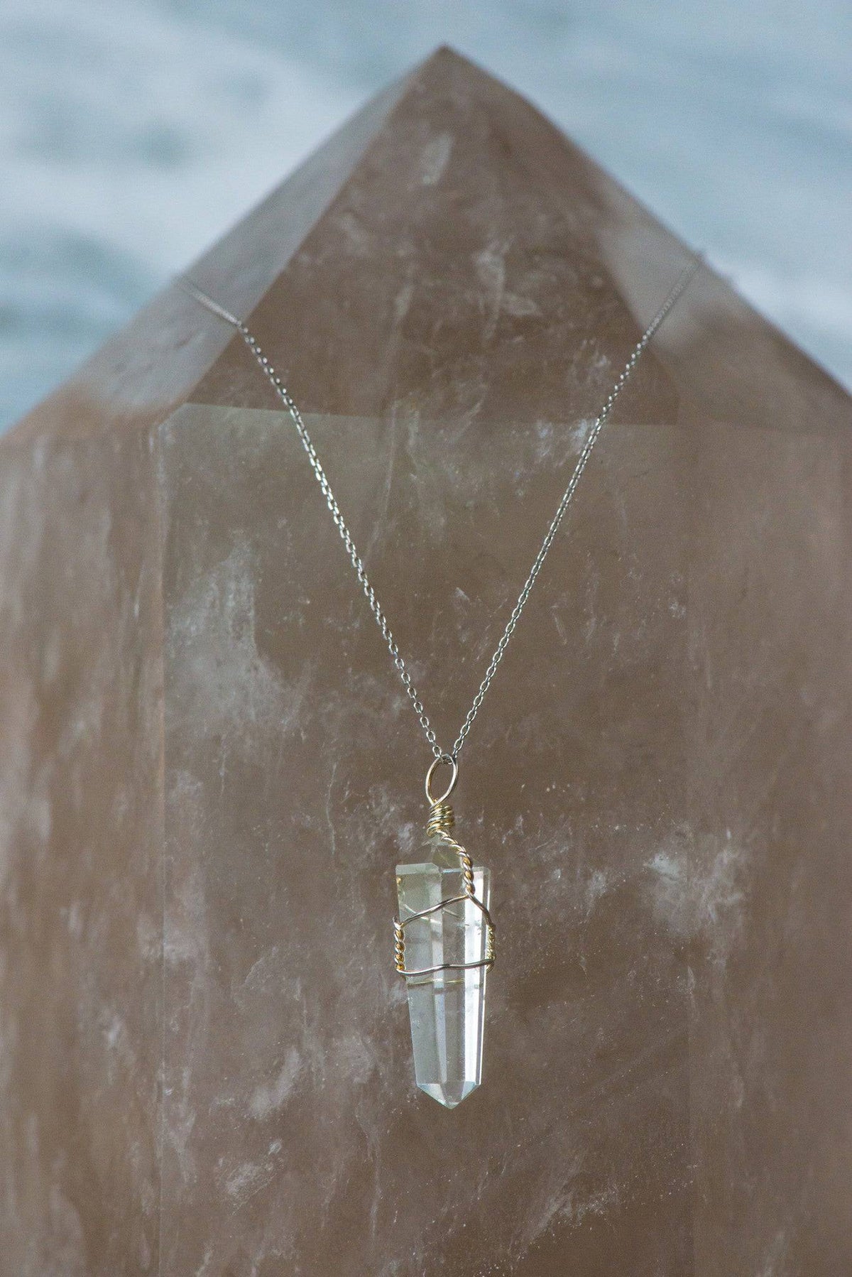 Wire wrapped clear quartz point necklace featuring a natural crystal pendant from Sacred Light Soundbaths and Crystals.