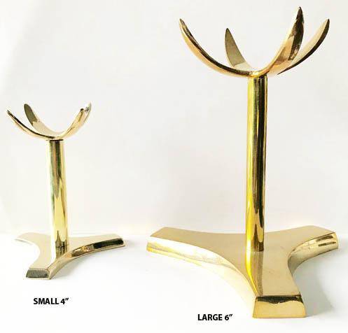 Brass 4 prong crystal specimen stand holding a clear crystal, designed for display and support of healing crystals.