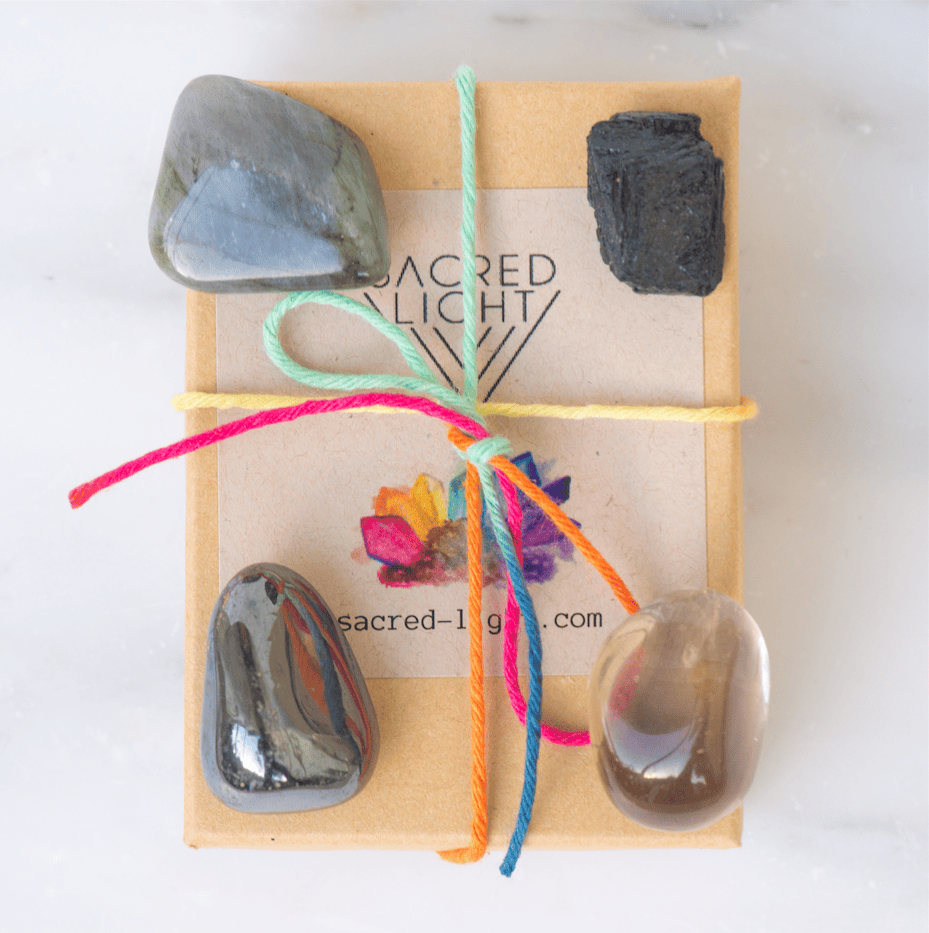 Sacred Light Soundbaths and Crystals Protection Gem Stone Set featuring various polished gemstones on a neutral background.