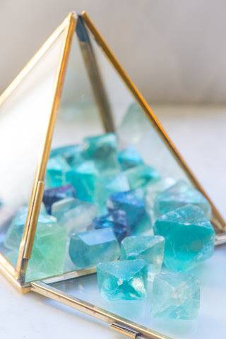 Natural fluorite octahedron stone from Sacred Light Soundbaths and Crystals, showcasing vibrant green and purple mineral formations.
