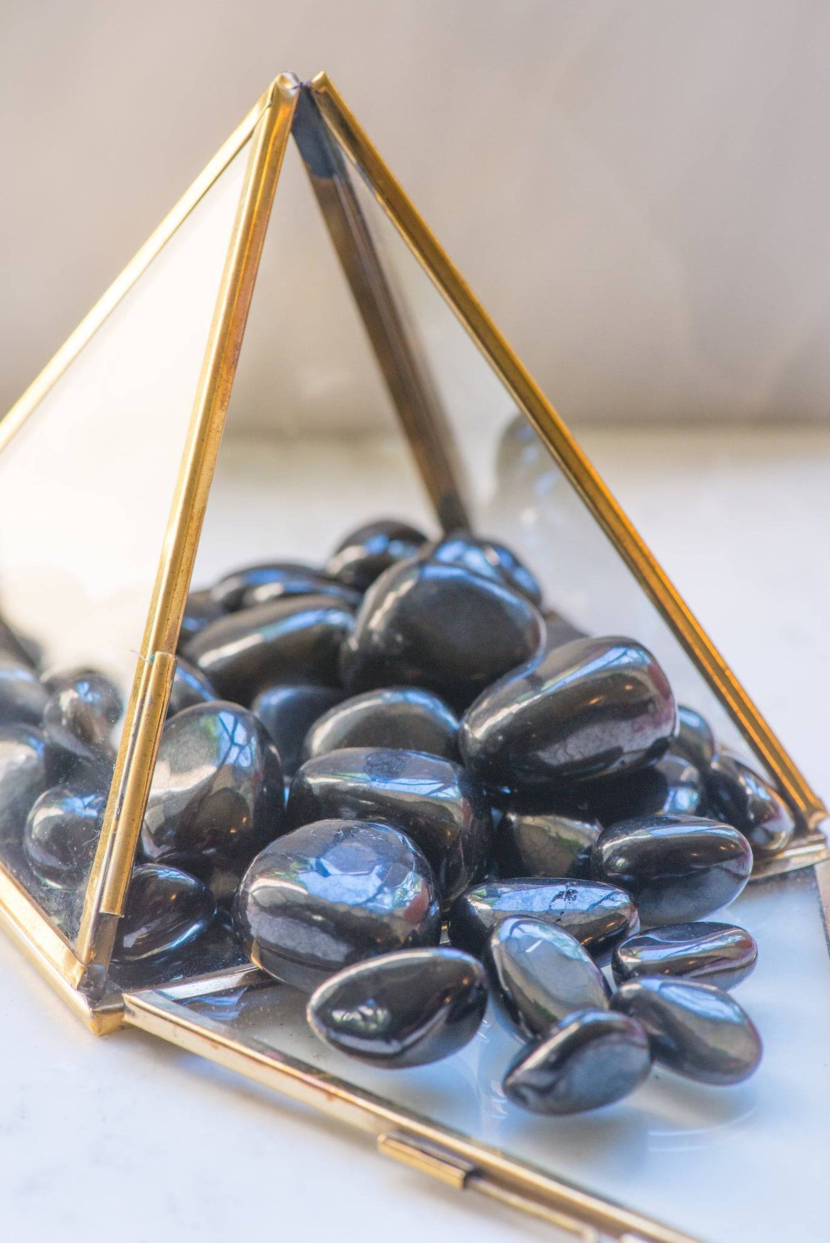 Shungite stone from Sacred Light Soundbaths and Crystals, natural black mineral with unique textured surface.