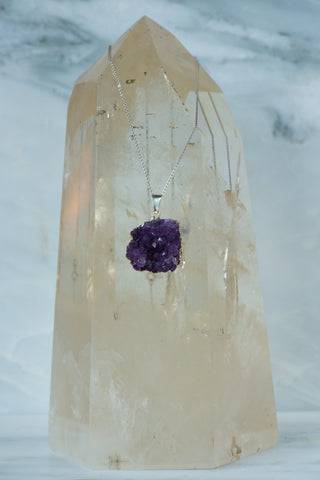 Sterling silver necklace with a natural purple amethyst gemstone, featuring a delicate chain and polished finish.
