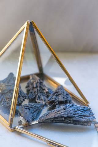 Natural black Kyanite stone from Sacred Light Soundbaths and Crystals, showcasing its deep, polished black mineral surface.