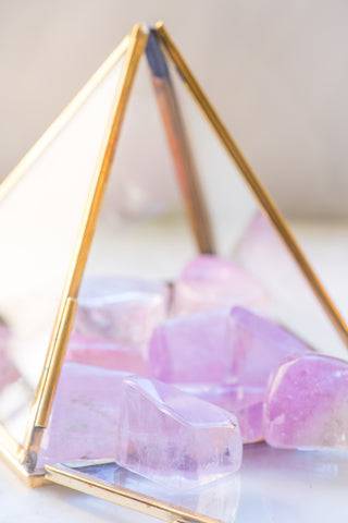 Tumbled Kunzite stone from Sacred Light Soundbaths and Crystals, showing soft pink coloration and smooth polished surface.