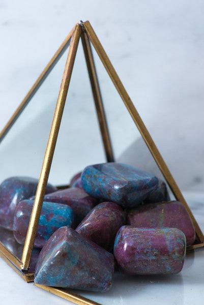 Tumbled ruby and blue kyanite stones from Sacred Light Soundbaths and Crystals, showcasing vibrant red and blue mineral textures.