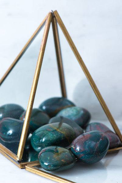 Tumbled Bloodstone stone from Sacred Light Soundbaths and Crystals, polished red and green gemstone with smooth surface.