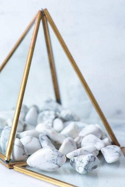 Tumbled Howlite stone from Sacred Light Soundbaths and Crystals, smooth, polished mineral with white and gray marbling.