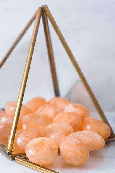 Tumbled Peach Stilbite stone from Sacred Light Soundbaths and Crystals, showcasing smooth, rounded peach-colored crystal stone.