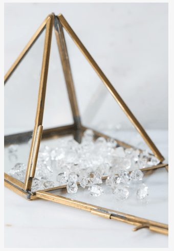 Natural Herkimer diamond stones from Sacred Light Soundbaths and Crystals, showcasing clear, faceted quartz crystals on a neutral background.