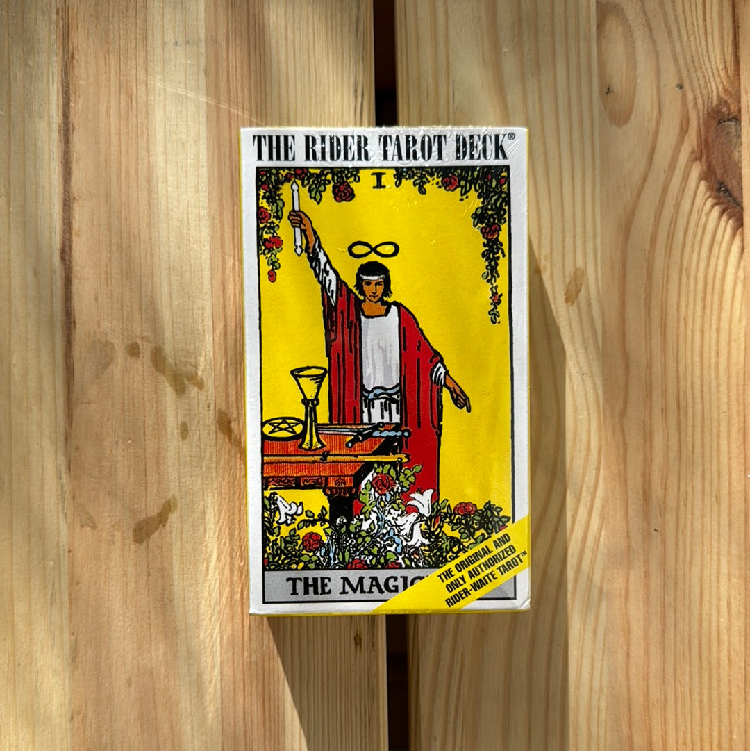 The Rider Tarot Deck by Sacred Light Soundbaths and Crystals featuring a colorful, detailed illustration of tarot cards on a wooden table.