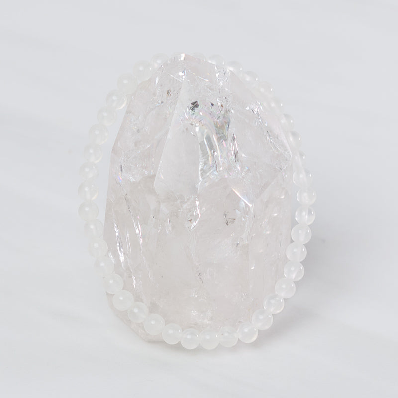 Dainty Selenite bracelet by Milk and Honey featuring smooth, polished white gemstone beads on an elastic band.