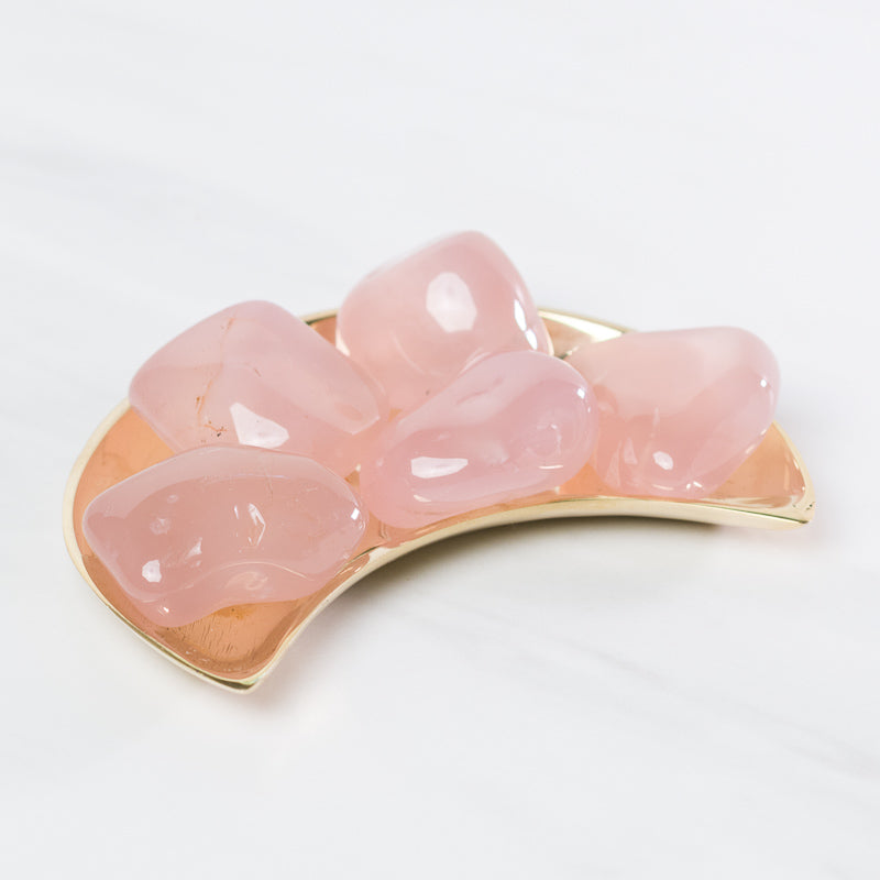 Tumbled pink chalcedony stone from Sacred Light Soundbaths and Crystals, smooth pink gemstone with a polished surface.