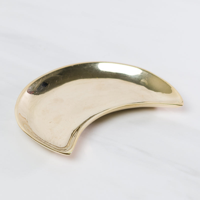 Brass moon-shaped dish from Sacred Light Soundbaths and Crystals, decorative accessory with polished metallic finish.