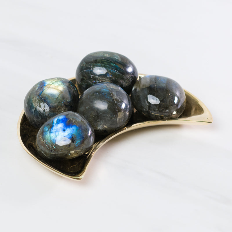 Labradorite gemstone from Madagascar, polished stone showcasing iridescent blue and green flashes, from Sacred Light Soundbaths and Crystals.