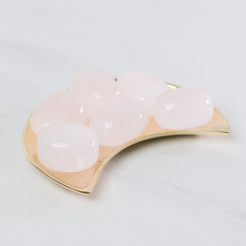 Tumbled pink calcite stone from Sacred Light Soundbaths and Crystals, smooth, polished crystal with soft pink hues and natural texture.