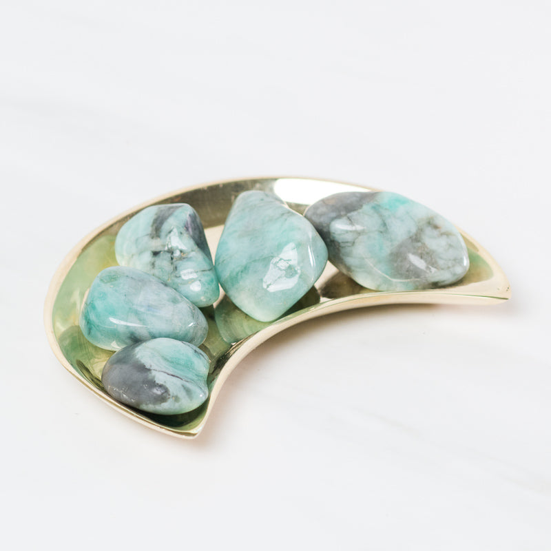 Tumbled emerald stone from Sacred Light Soundbaths and Crystals, showcasing smooth, polished green gemstone with natural veining.