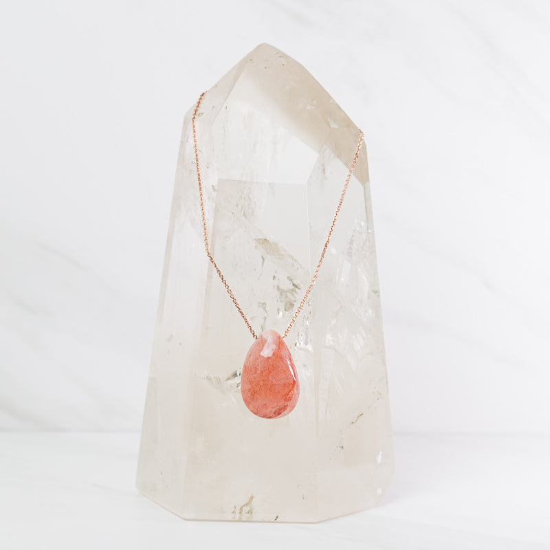 Hematoid teardrop necklace from Sacred Light Soundbaths and Crystals, featuring a polished red and gold-toned gemstone pendant.