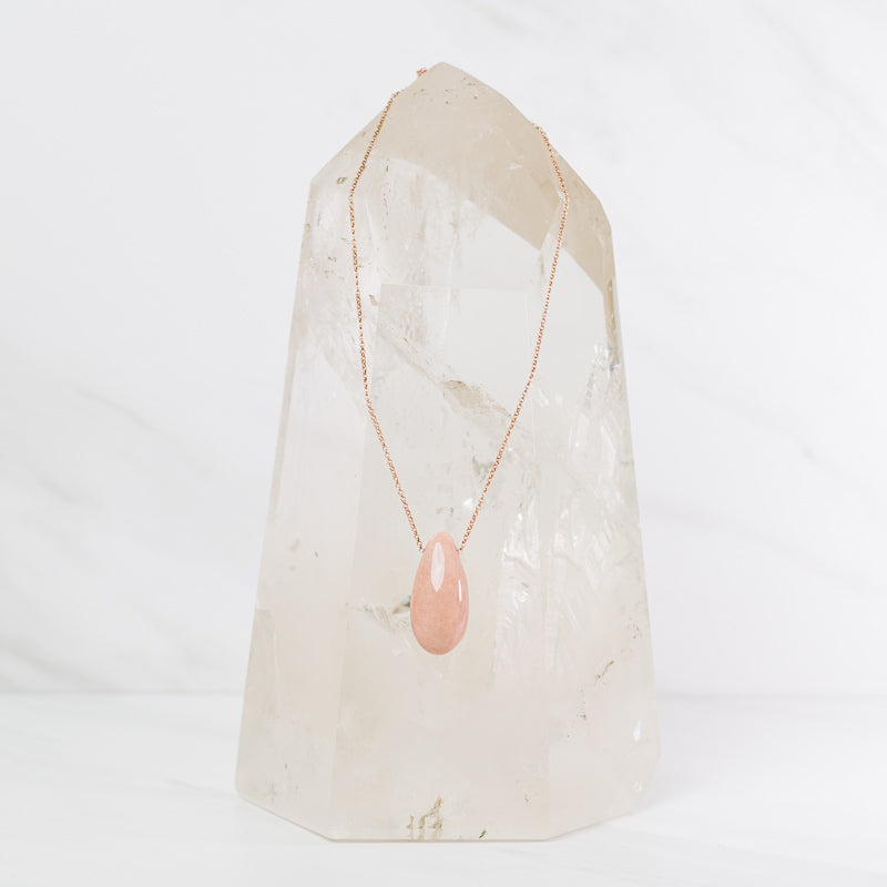 Peach moonstone teardrop necklace from Sacred Light Soundbaths and Crystals, featuring a polished peach moonstone pendant on a delicate chain.