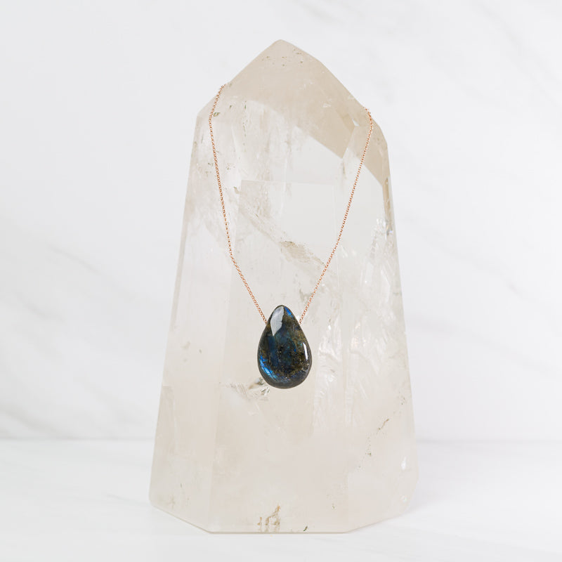 Labradorite teardrop necklace featuring a polished gemstone pendant on a silver chain, from Sacred Light Soundbaths and Crystals.