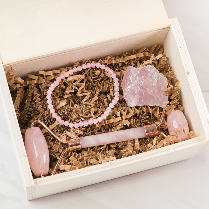 Sacred Light Soundbaths and Crystals Rose Quartz face massage roller set with dual rollers and storage pouch for skincare.
