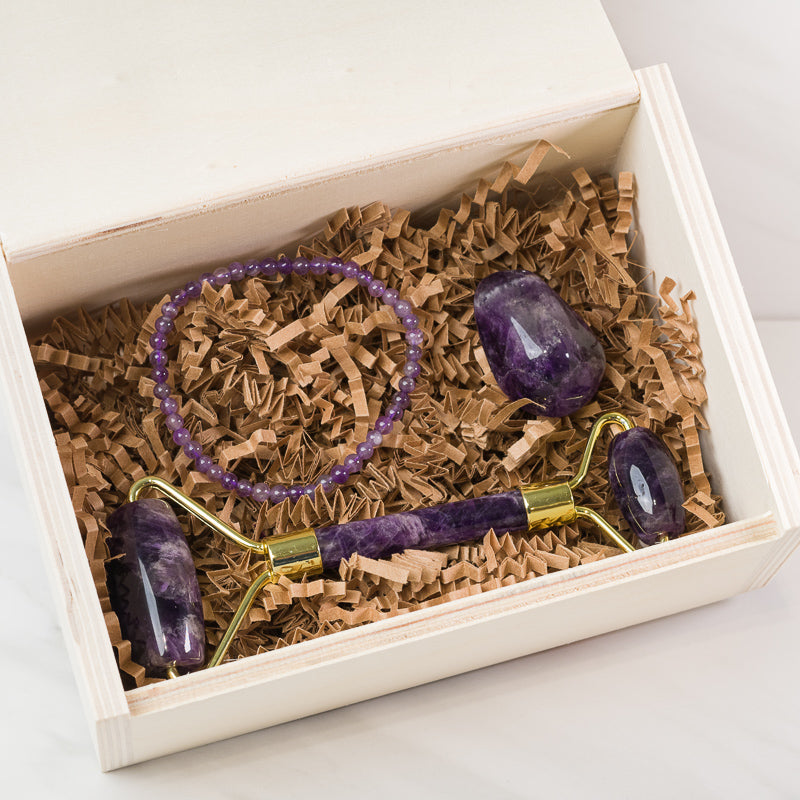 Amethyst soothing face massage roller from Sacred Light Soundbaths and Crystals, shown with smooth lavender-colored stone and ergonomic handle.